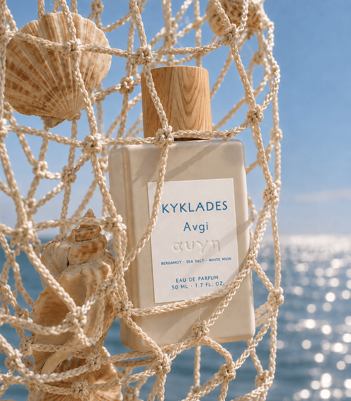 KYKLADES Avgi perfume in a marine net with seashells and sea background
